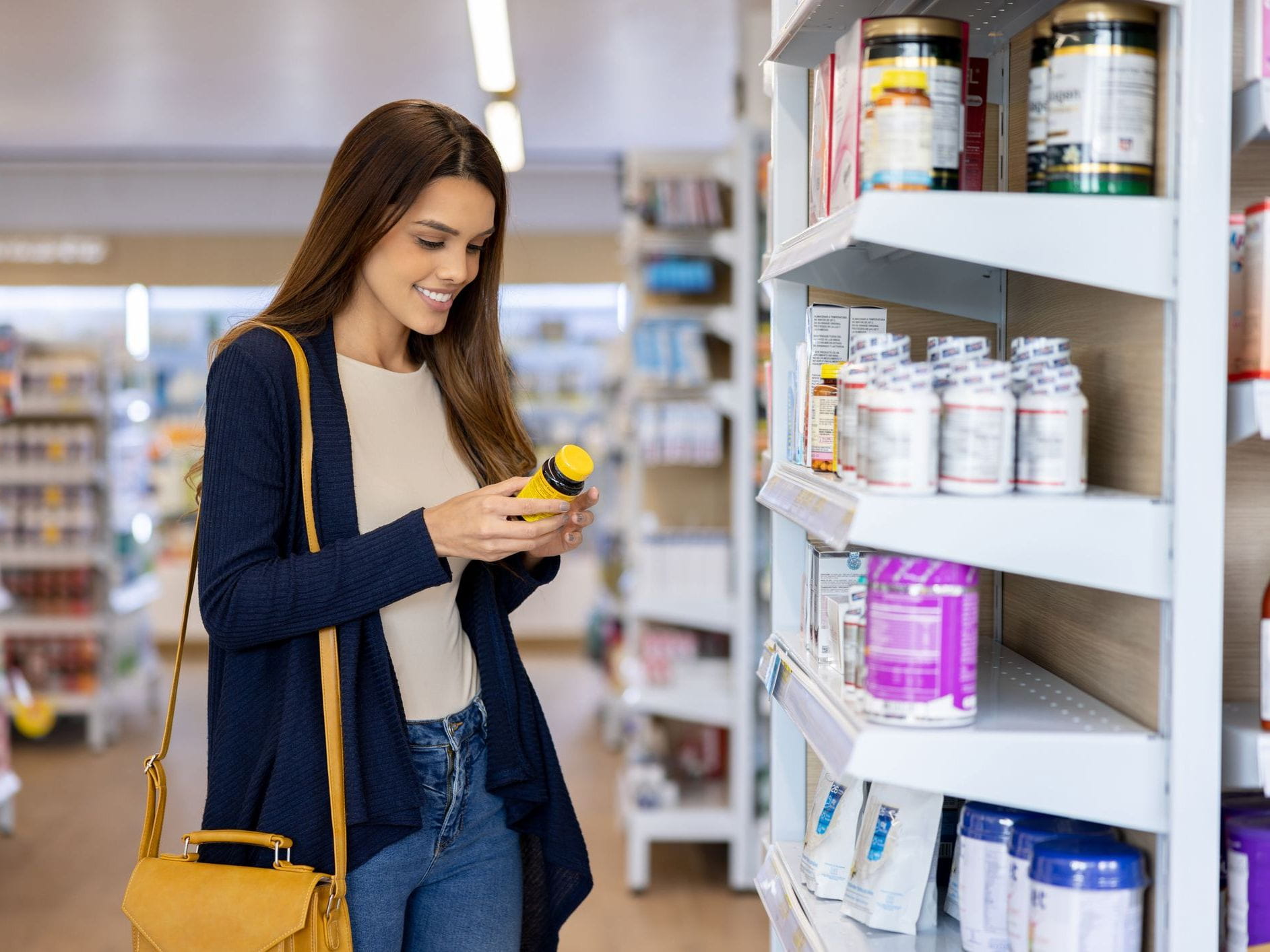 woman buying multivitamins at pharmacy