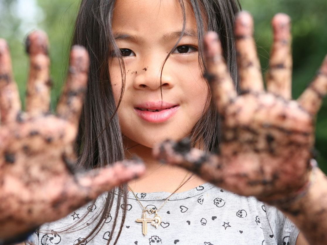child with dirty hands