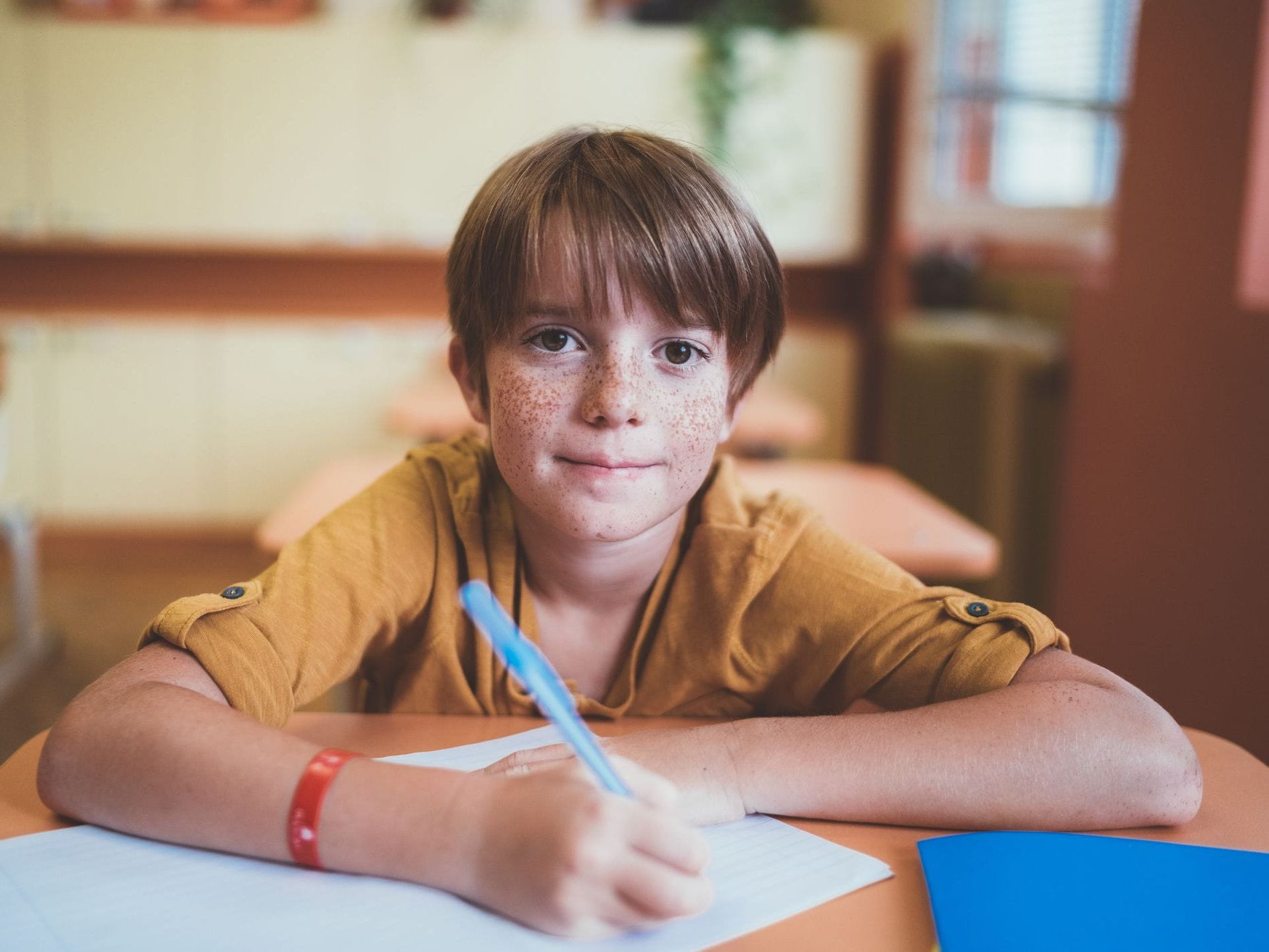 kid writing with pen