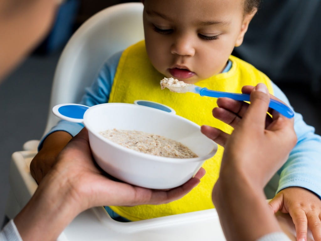 baby boy eating rice cereal