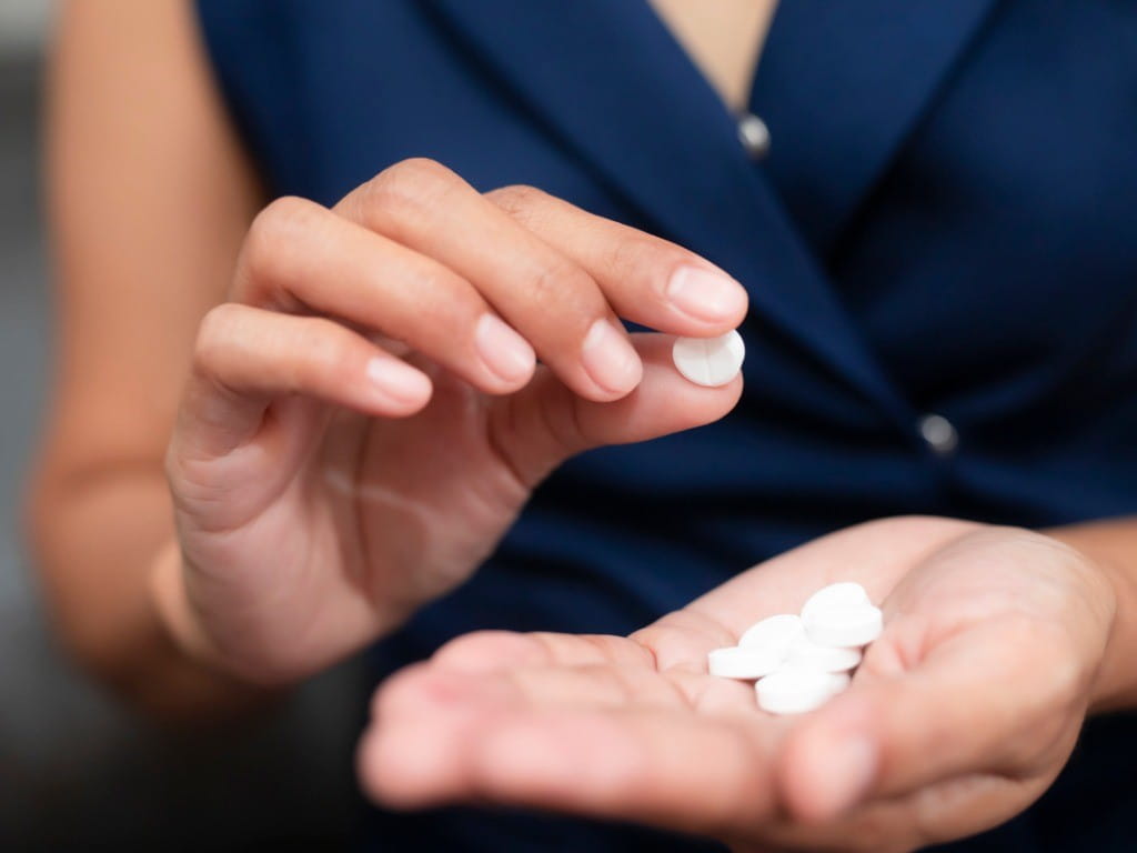 brexpiprazole woman holding antidepressant pill