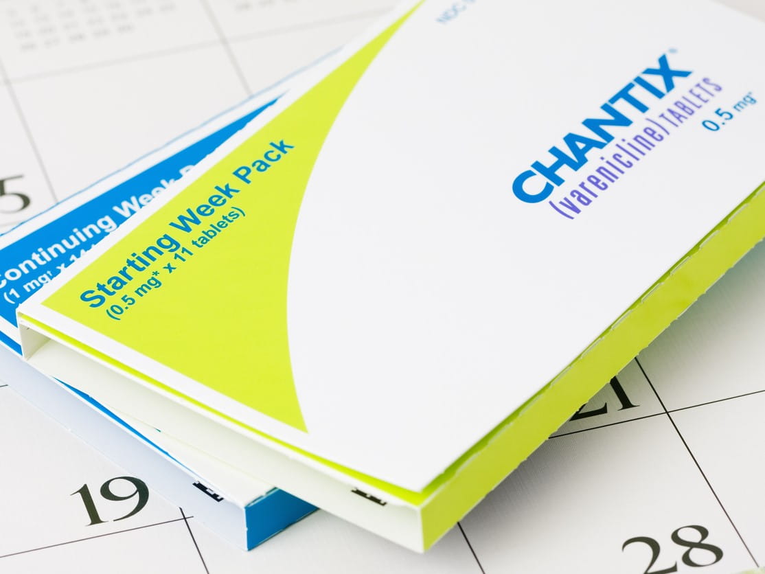 two boxes of chantix stacked on top of a calendar