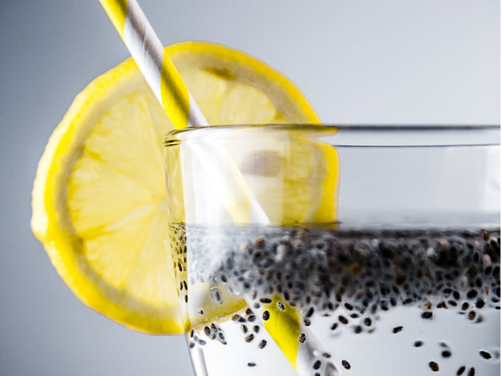 chia seeds in water with lemon and a straw chia seeds in water with lemon and a straw