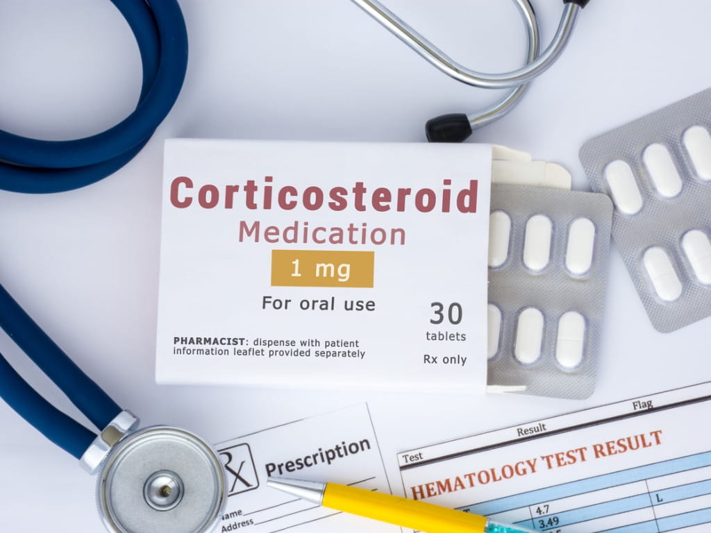 corticosteroid medication next to stethoscope and prescription