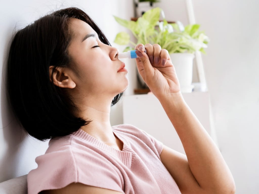 dizzy woman using smelling salts