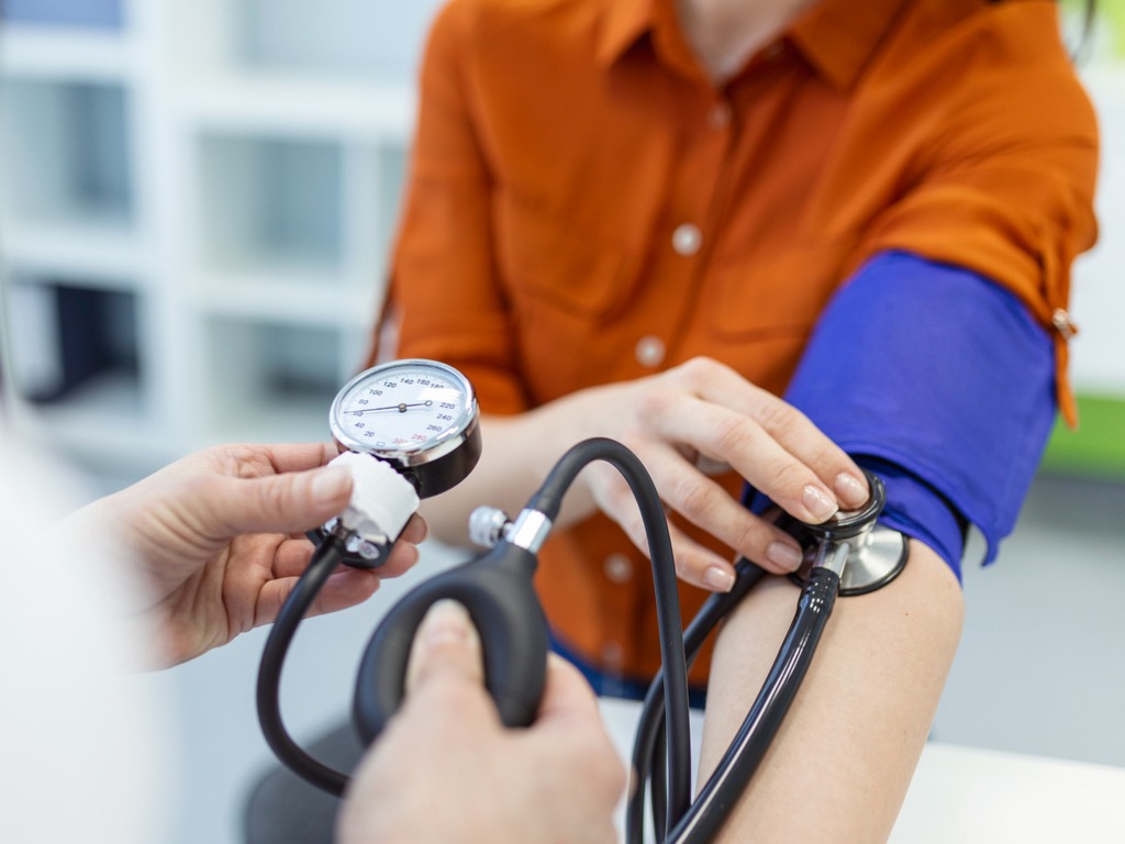 doctor checking blood pressure