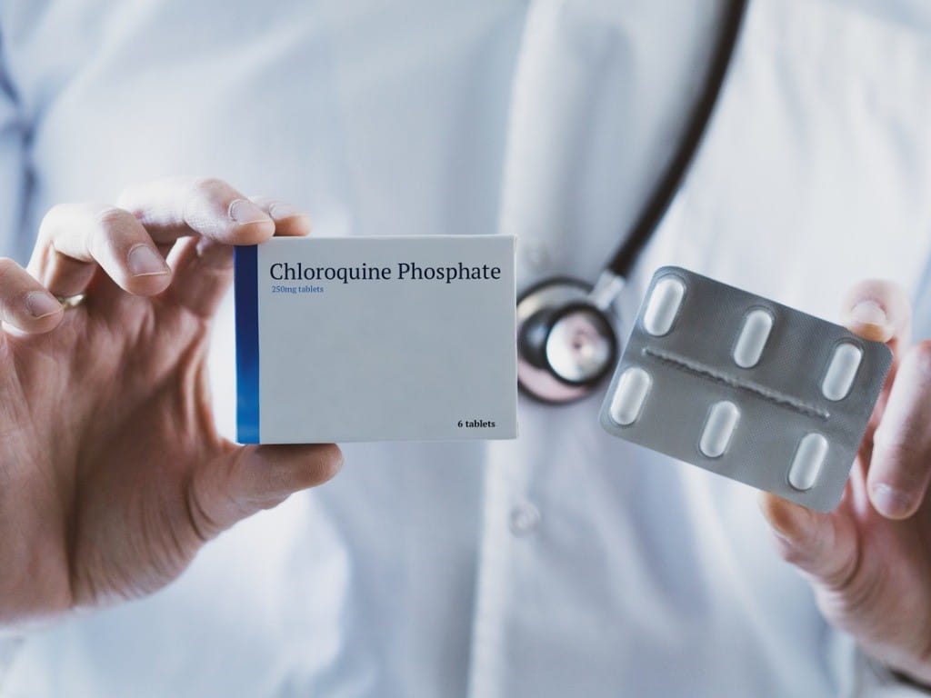 doctor holding chloroquine pills