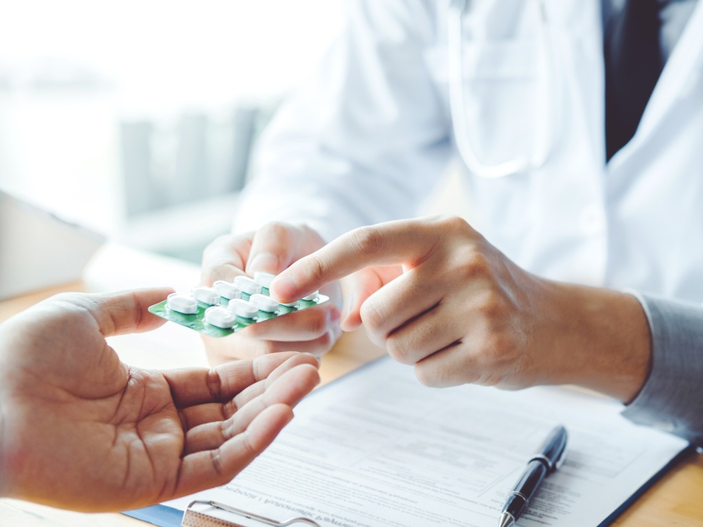 doctor handing medicine to a patient