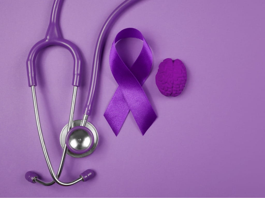 purple epilepsy ribbon, stethoscope and foam brain