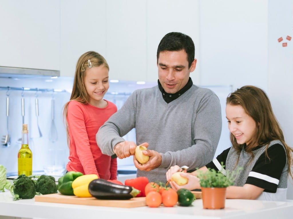 green potatoes dad and daughters making dinner