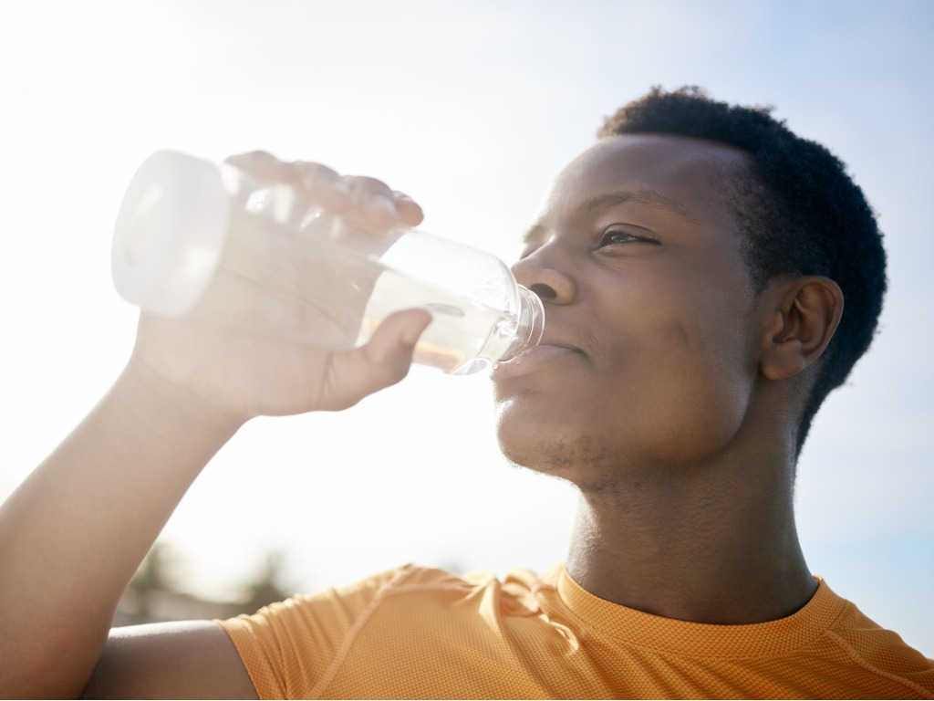 jogger drinking a bottle of water