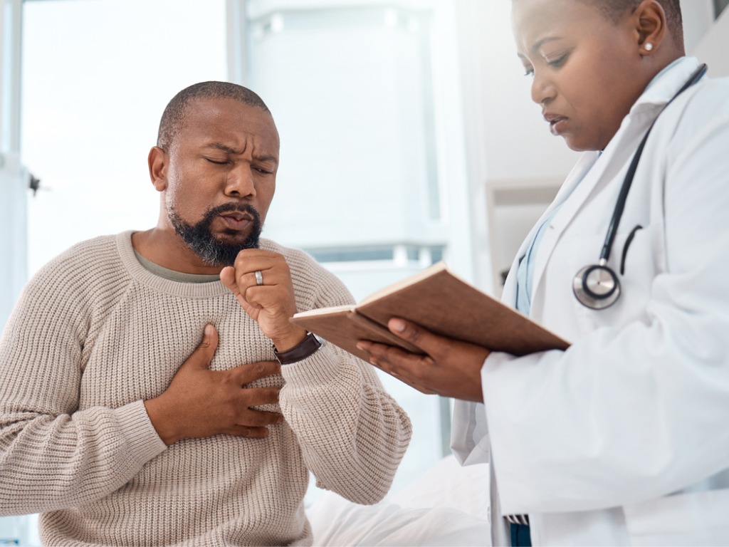 man coughing at the doctor's office