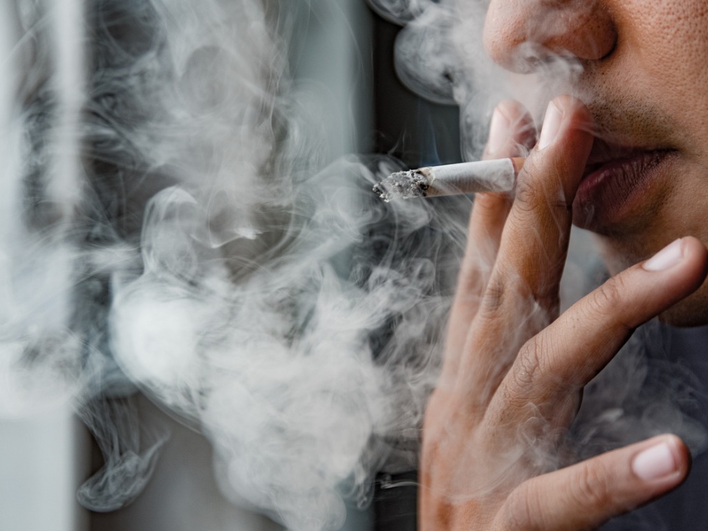 Person smoking cigarette Person smoking cigarette