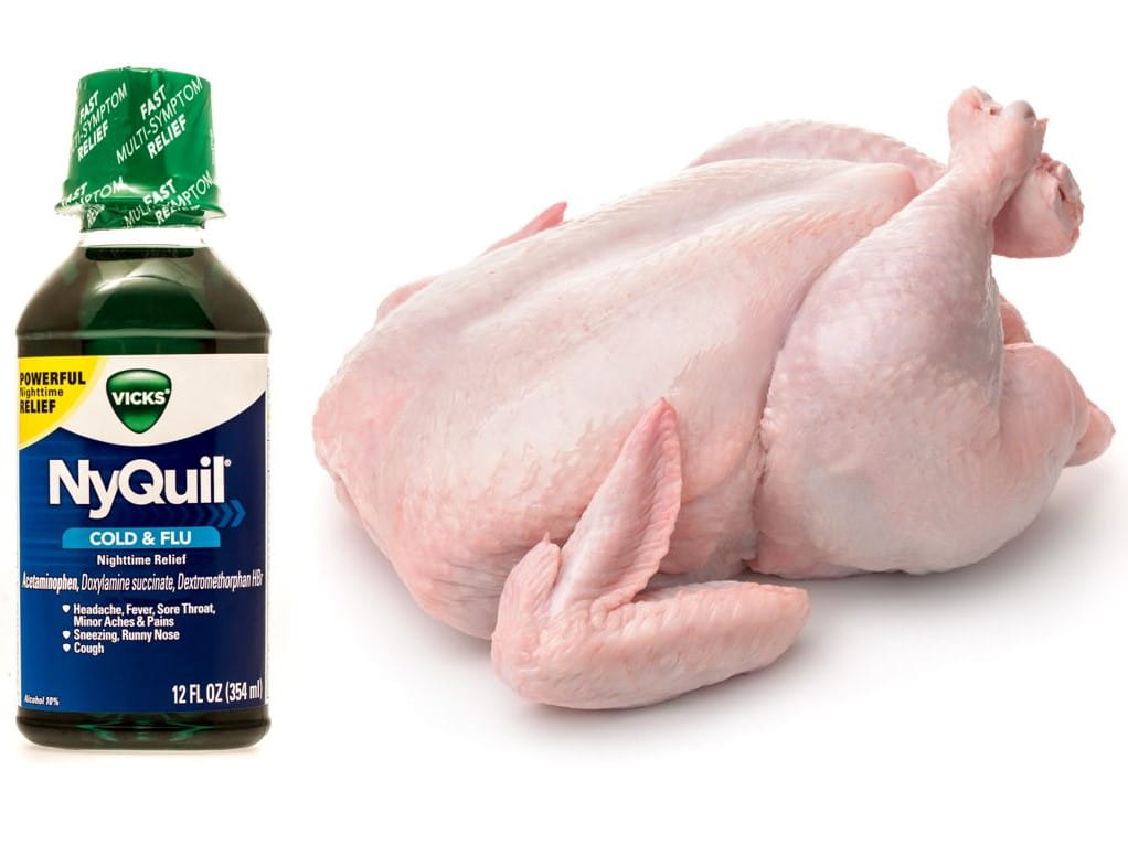 a bottle of nyquil next to a raw chicken