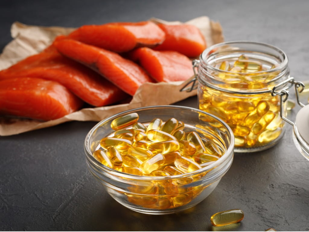 omega-3 capsules and raw salmon