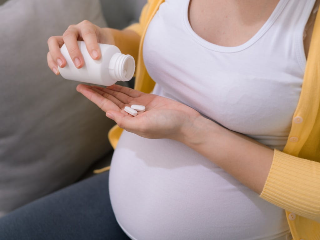 pregnant woman taking medicine