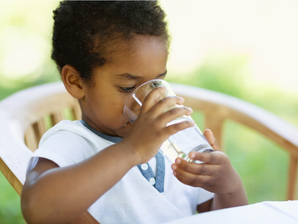 toddler drinking glass of water