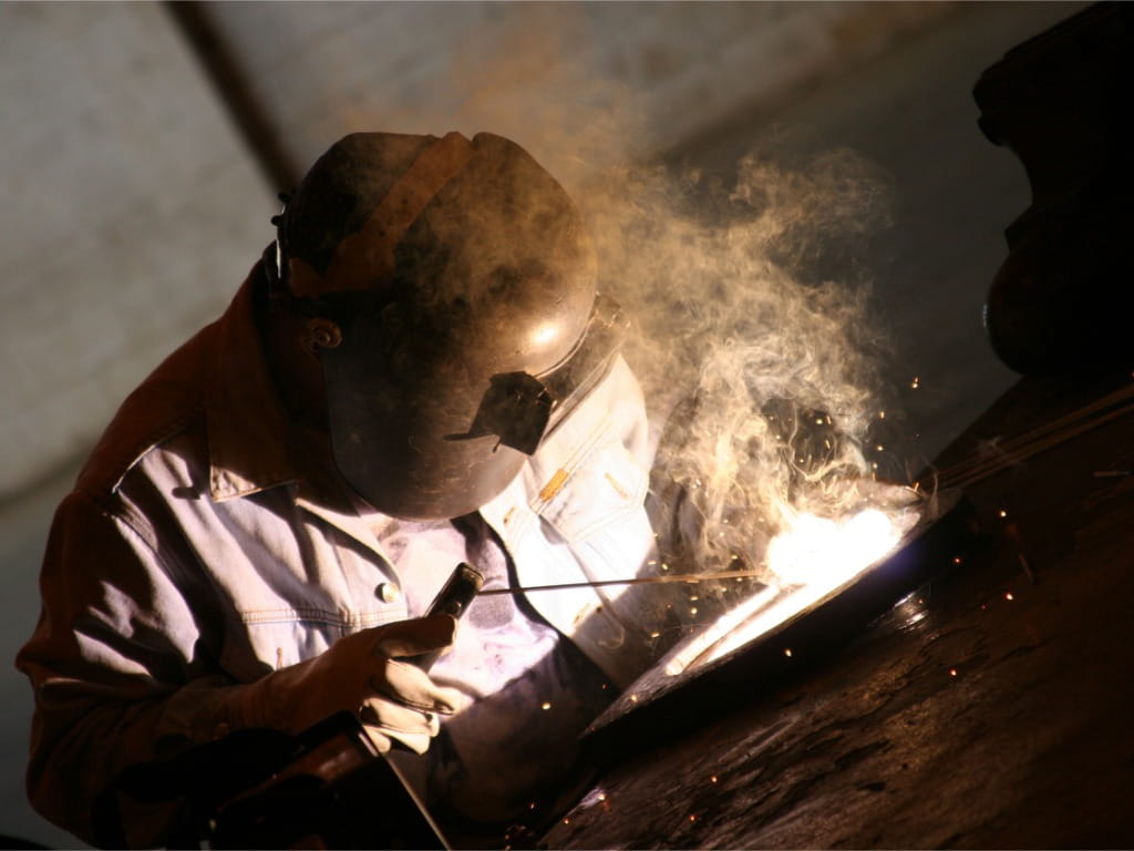 worker welding metal