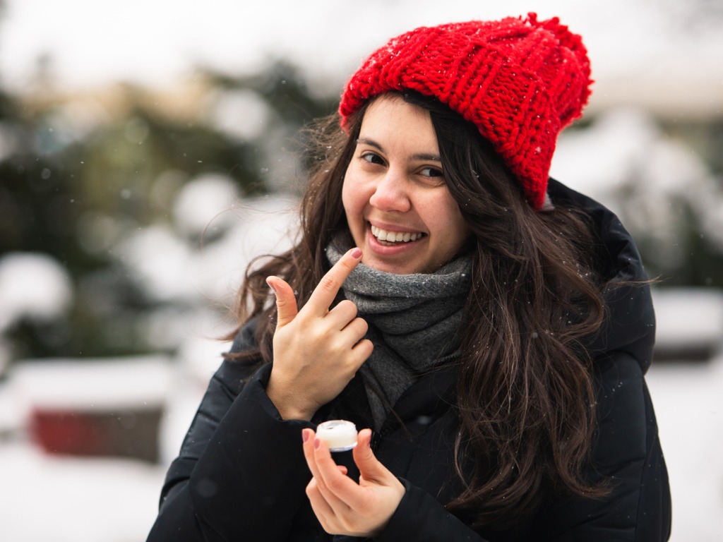 woman applying vaseline to her lips