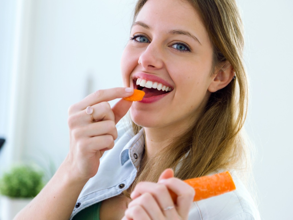 woman eating a carrot