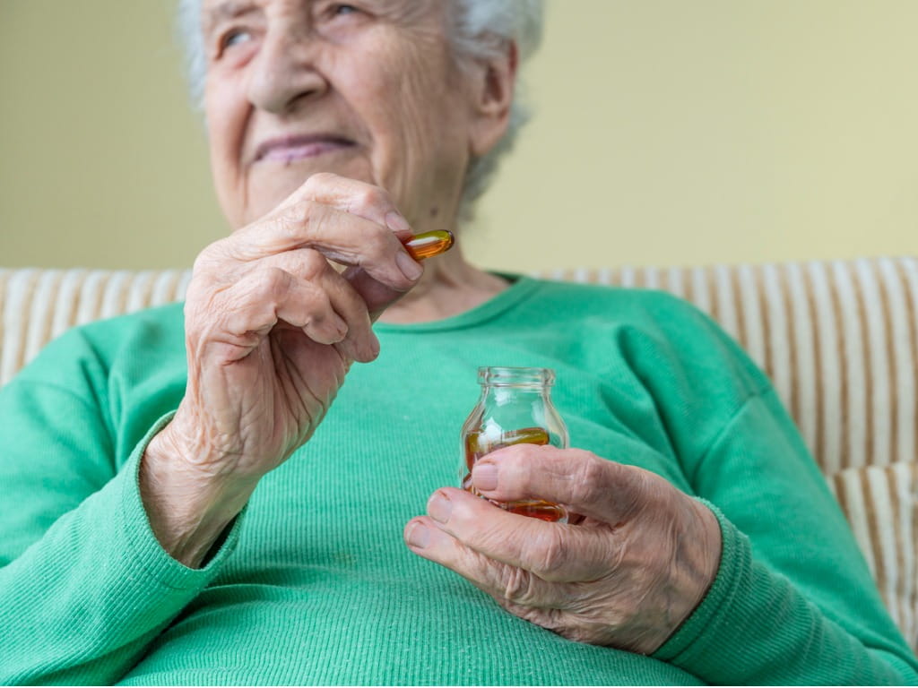 women holding omega-3 capsule