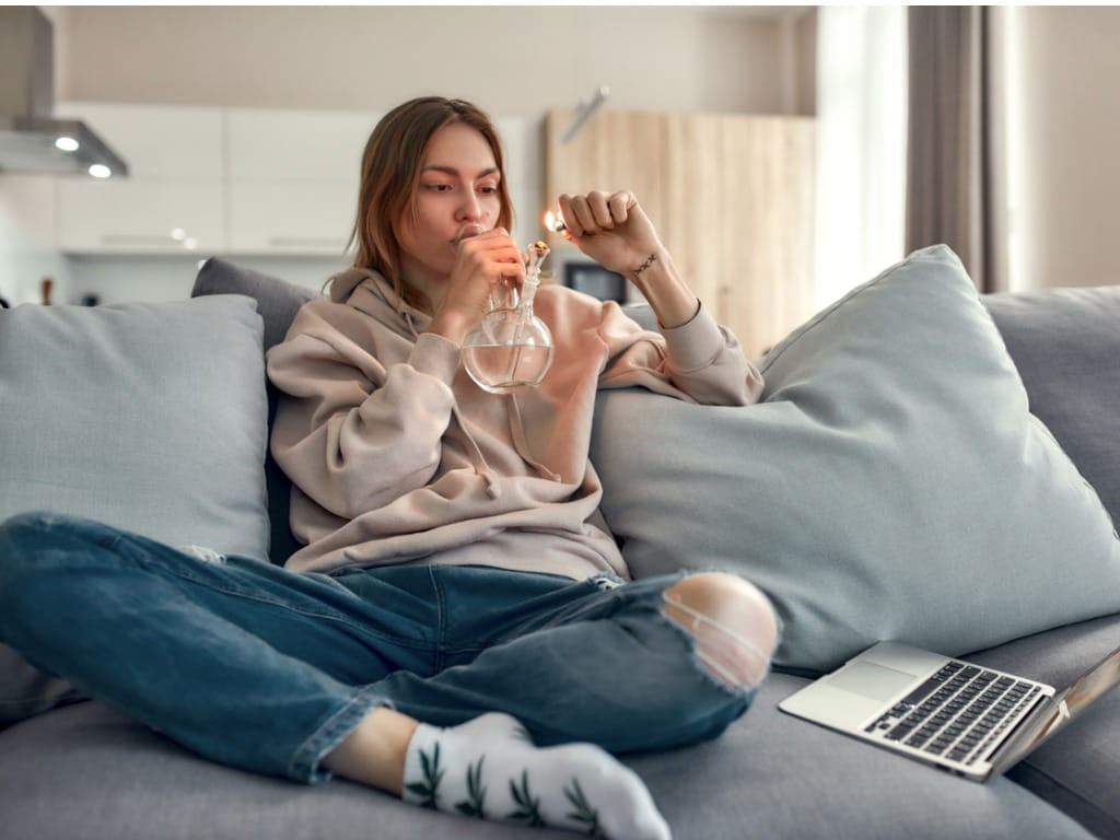 woman smoking marijuana from a bong