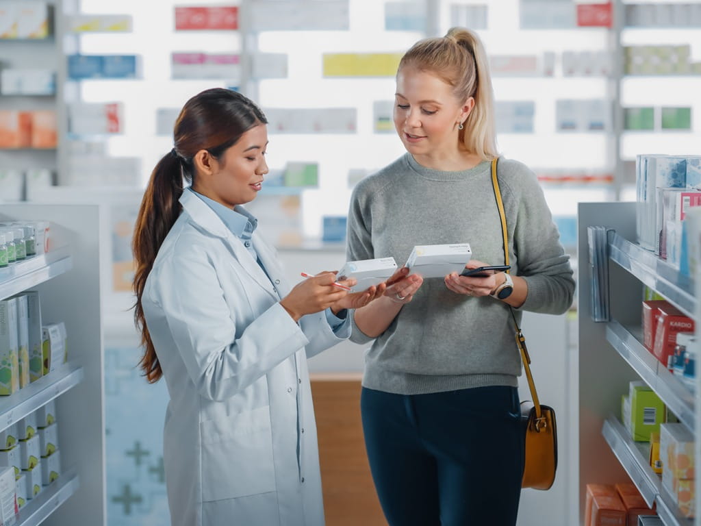 woman speaking with a pharmacist about medication