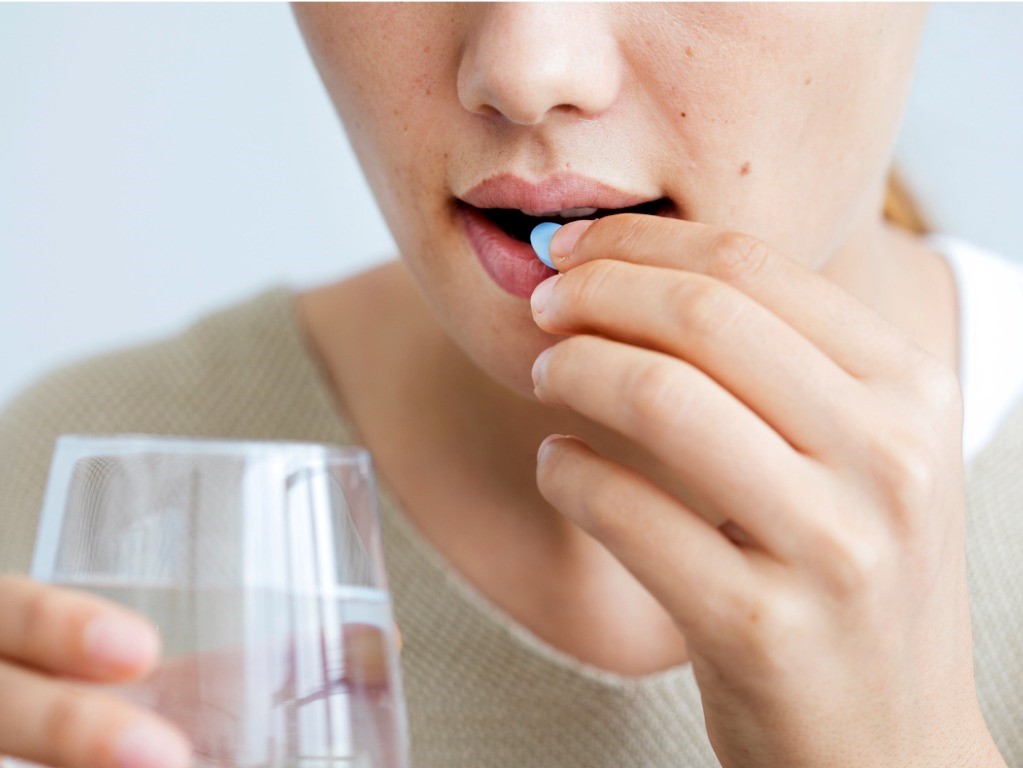 woman taking a pill