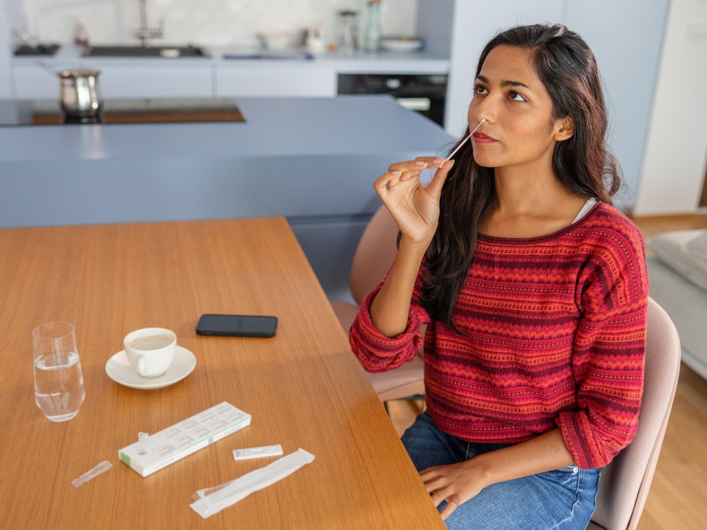 woman taking COVID-19 rapid antigen test