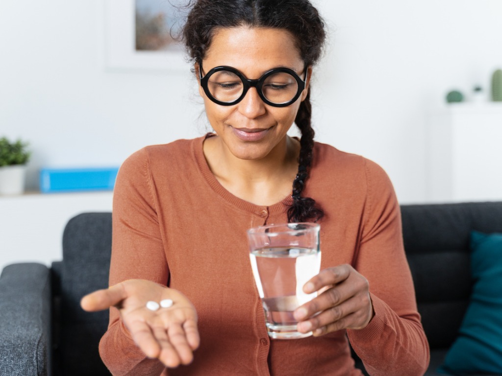 woman taking medication