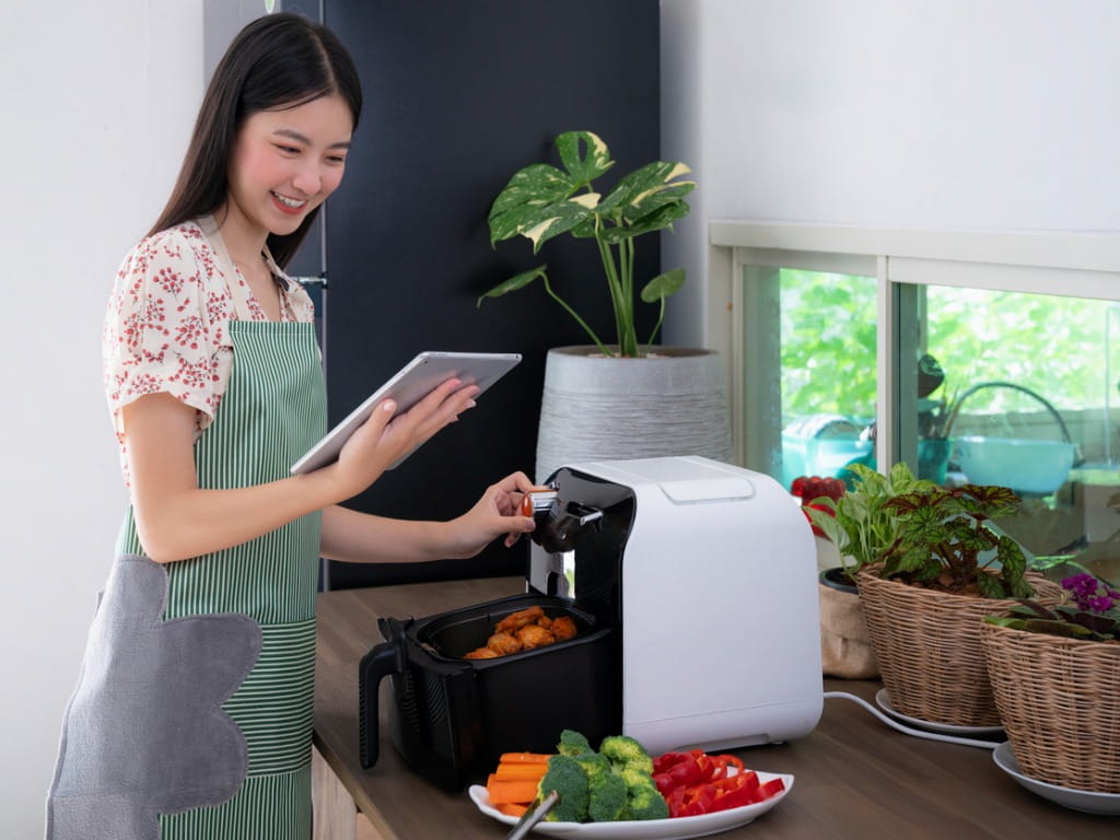 woman using an air fryer