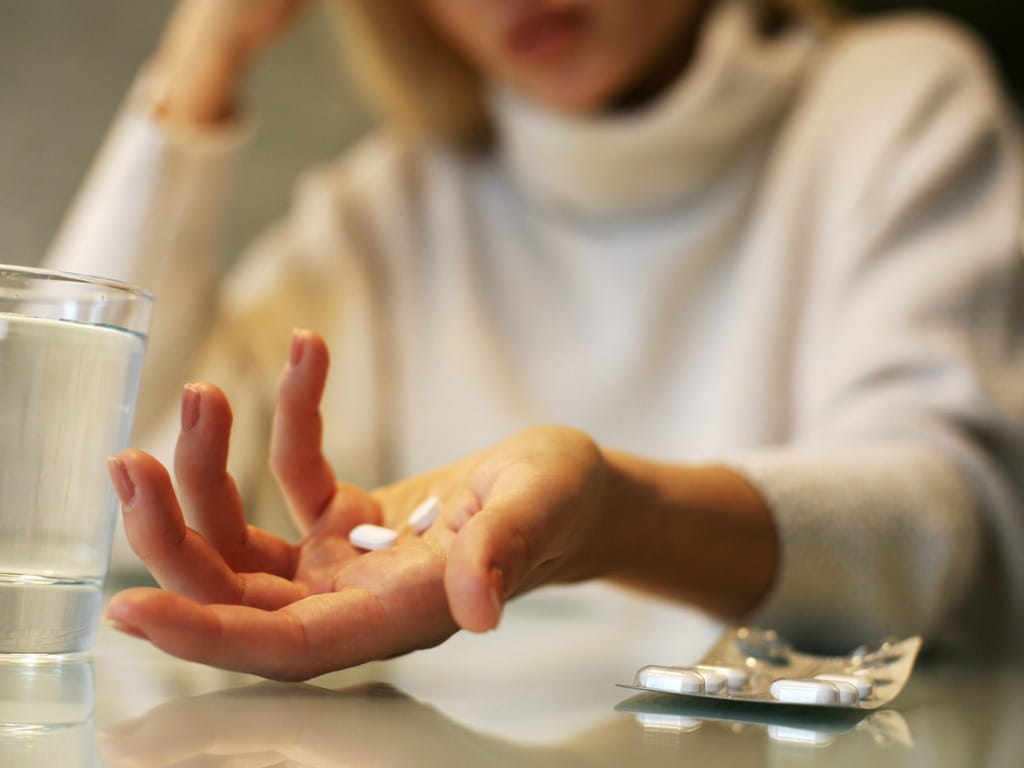 woman with medication in hand