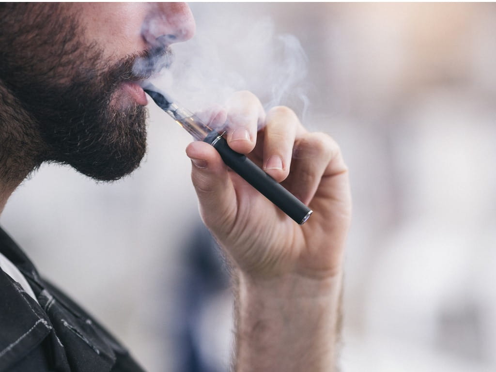 young man smoking a vape